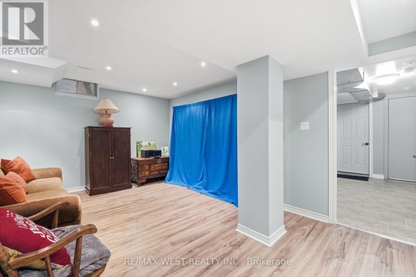 Basement sitting area with sofa, armchair, and wood furniture - 149 Deerglen Terrace Aurora