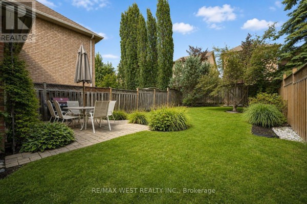 Backyard with patio, dining set, grill, and lawn - 149 Deerglen Terrace Aurora