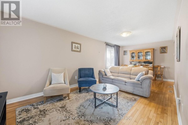 Beige sofa, cream armchair, blue accent chair, coffee table on rug - 149 Deerglen Terrace Aurora
