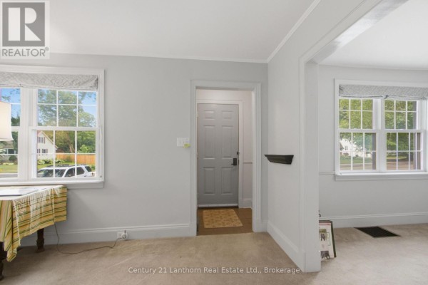 Interior view of the entrance hallway with light grey walls and a door leading outside. - 149 Dufferin Avenue, Belleville