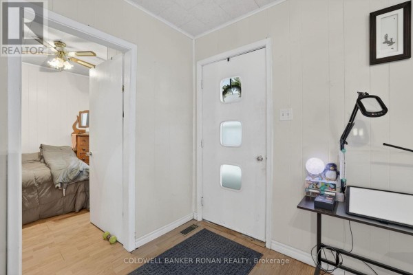 Interior hallway with a white door leading to a bedroom and a desk. - 149 Victoria Street W, New Tecumseth
