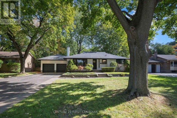 Front view of the house with trees and a long driveway. - 1492 North Vernon Avenue, London North