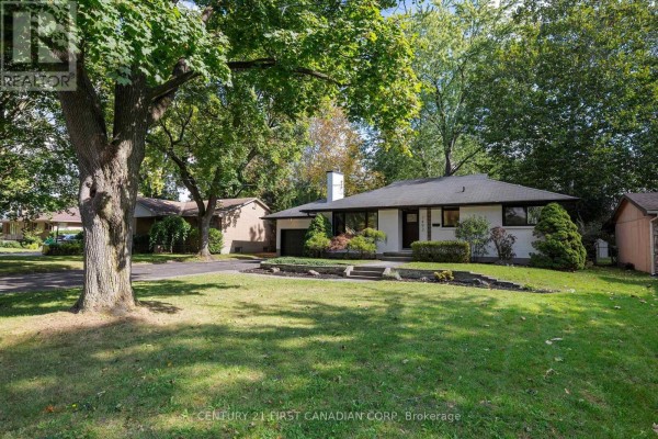 View of the house from the right side showing the garage and front yard. - 1492 North Vernon Avenue, London North