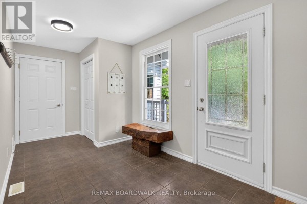 Sunroom with office desk and sliding glass doors opening to a backyard pool. - 14930 Concession 10-11 Road, North Stormont