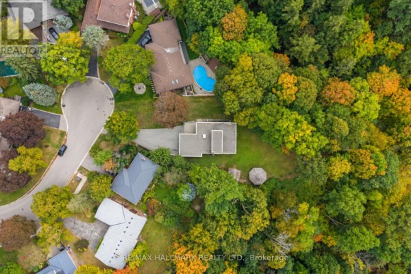 Aerial view of a residential house surrounded by mature trees and foliage. - 1499 Ashington Court, Mississauga