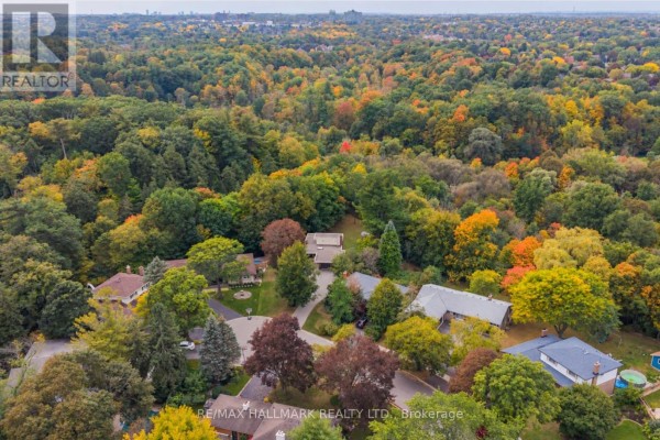 Aerial view of a neighborhood with houses nestled among abundant trees in autumn colors. - 1499 Ashington Court, Mississauga