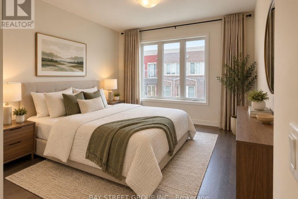 Bedroom with pale pink walls, dark hardwood floors, and a large window with patterned curtains. - 15 - 115 Long Branch Avenue, Toronto