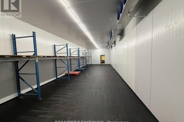 Storage area with a door leading to an empty workspace - 15 - 140 Finchdene Square, Toronto