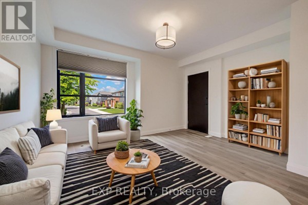Living room with white sofa, striped rug, wood coffee table, and large window. - 15 - 3900 Savoy Street, London South