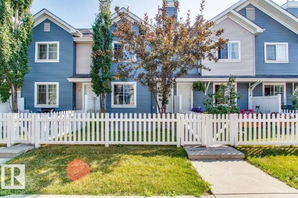 Kitchen with dark appliances, wooden cabinets, granite counters, and laminate flooring. - #15 8304 11 Av Sw, Edmonton