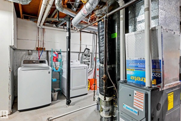 Basement laundry room with white washer and dryer, and furnace. - 15 Akinsdale Gd, St  Albert