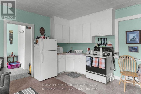 Another angle of the kitchen showing white cabinetry and dining setup. - 15 Albert Street, Selwyn