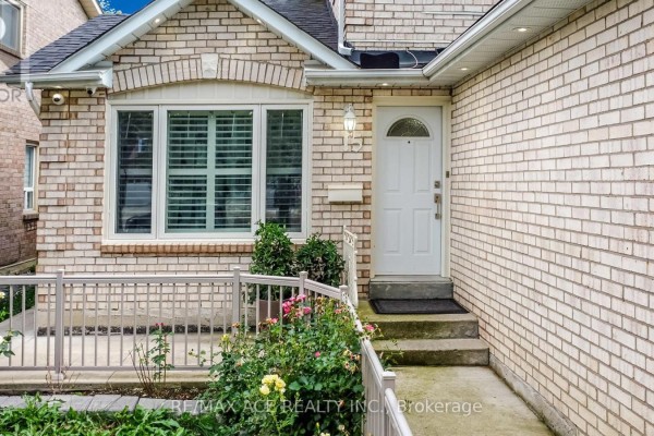 Entryway with brick facade, front door, and flower beds - 15 Brennan Road, Ajax