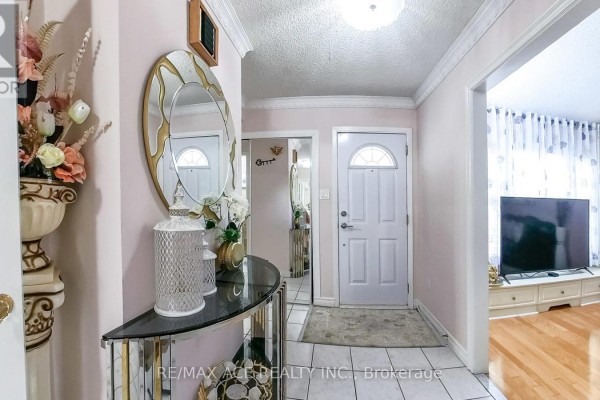 Interior hallway with tile flooring, mirror, and light fixture - 15 Brennan Road, Ajax