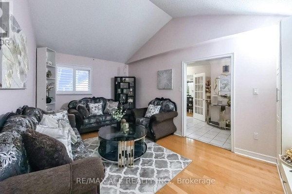 Another angle of the living room with a cozy seating arrangement and open layout - 15 Brennan Road, Ajax