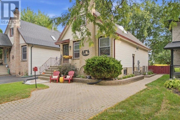 Backyard with a wooden deck, patio area, lawn, fenced yard, and a view of the house. - 15 Chancton Crescent, London South