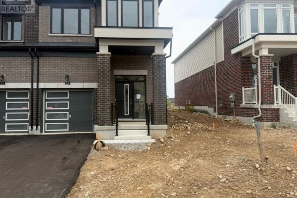 Close-up of the townhouse entrance with glass doors and a covered porch. - 15 Chapman Road, Brant