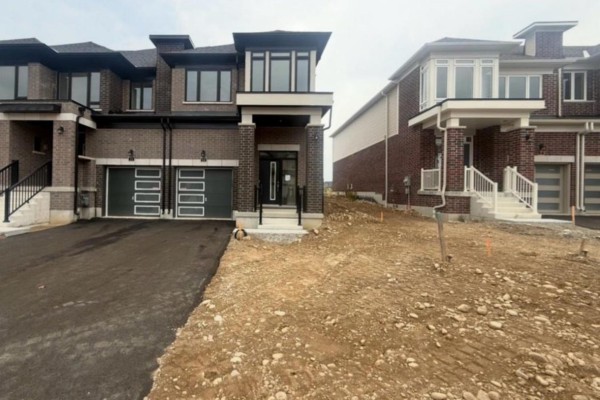 Street view showing a row of newly constructed townhouses under an overcast sky. - 15 Chapman Road, Brant