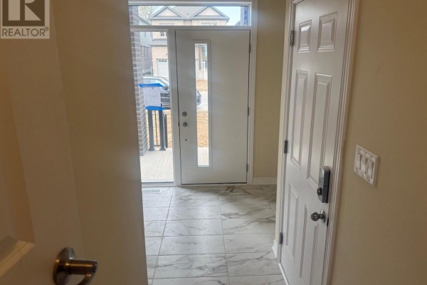 Entrance foyer with white doors, tiled floor, and a view of the exterior street. - 15 Chapman Road, Brant