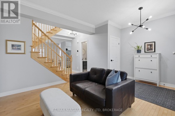 Living room with leather sofa, ottoman, chandelier, and shoe cabinet - 15 Cozocar Crescent St  Catharines