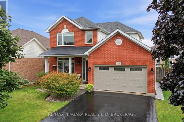 Two-story red brick house with attached garage and double driveway - 15 Cozocar Crescent St Catharines