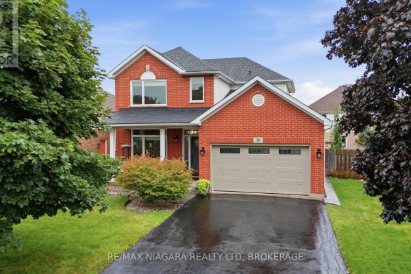 Red brick house with two-car garage and paved driveway - 15 Cozocar Crescent St Catharines