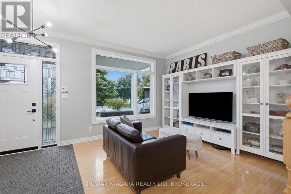 Brown leather sofa and white entertainment center with glass cabinets - 15 Cozocar Crescent St  Catharines