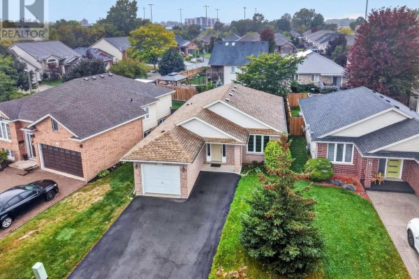 Aerial view of a residential street with a brick bungalow at 15 Days Avenue. - 15 Days Avenue, Welland