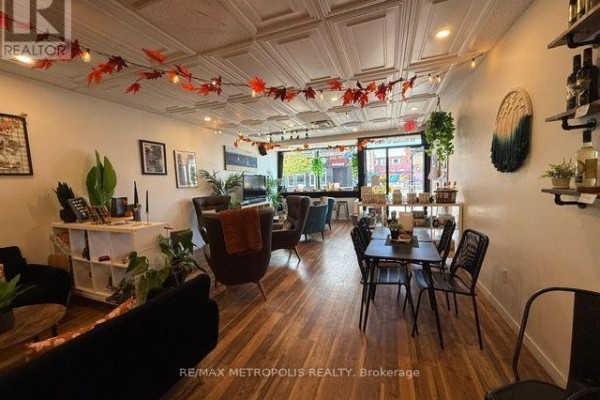 Interior seating area with couches, chairs, and tables, lit by string lights. - 15 Dunlop Street W, Barrie