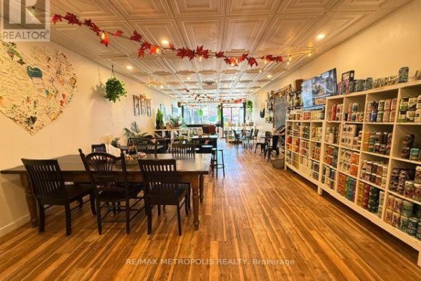 View of the interior showing seating areas, shelves, and display cases. - 15 Dunlop Street W, Barrie