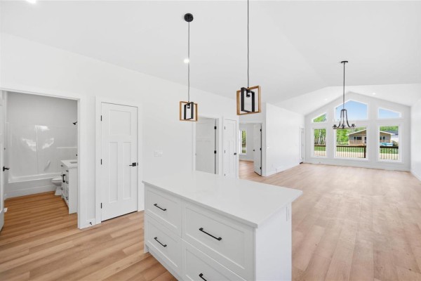 Interior kitchen island with pendant lights, showing doorways to bathroom and living area. - 15 Everwood Crescent, Matlock