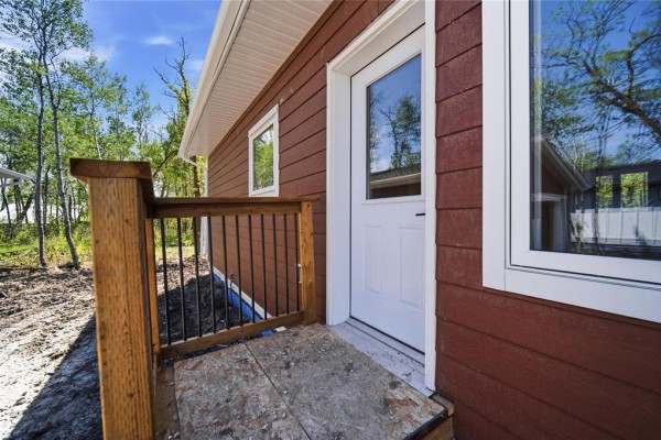 Exterior view of a red house with white trim, a door, and a wooden railing. - 15 Everwood Crescent, Matlock