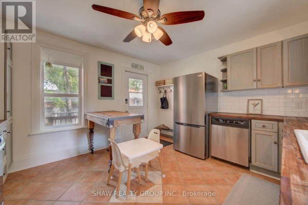 Stainless steel appliances, wooden countertops, and farmhouse table in kitchen - 15 Gilholm Avenue Cambridge