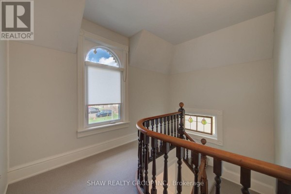 Curved wooden banister and arched window in hallway - 15 Gilholm Avenue Cambridge