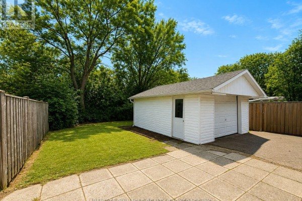 Two-car garage, paved driveway, and concrete patio - 15 Gregory Place St Thomas