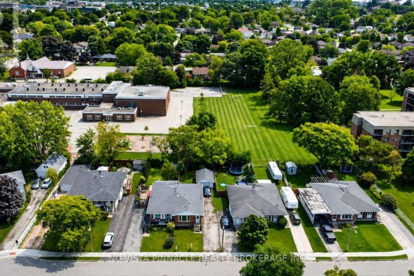 Aerial view of suburban neighborhood with school, homes, and apartment buildings.