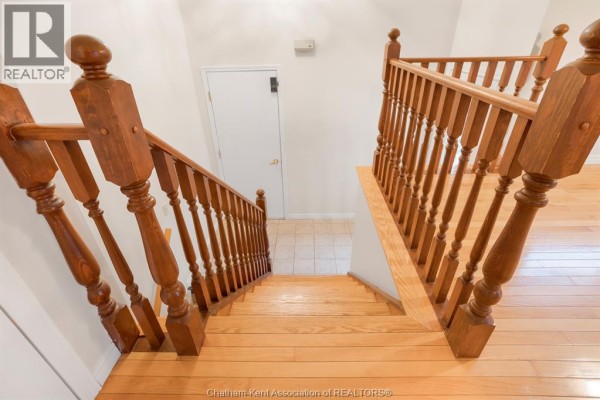 Kitchen with wooden cabinets, white appliances, and granite countertops - 15 Monarch Drive, Chatham