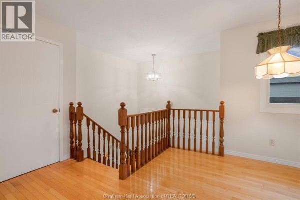 Hallway with carpet flooring, doors to rooms, and a dartboard on the wall - 15 Monarch Drive, Chatham