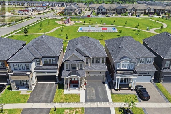 Aerial view of 15 Moriarity Drive and neighboring houses on a suburban street. - 15 Moriarity Drive, Brant