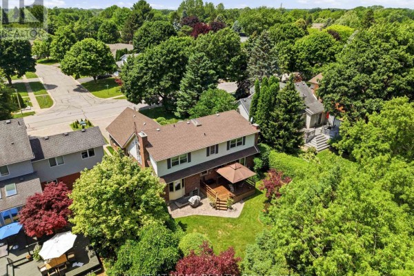 Aerial view of the rear of a two-story house with a wooden deck and backyard. - 15 The Promenade, Niagara On The Lake