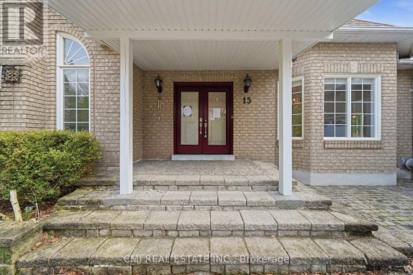 Close-up of the front entrance with double red doors, stone steps, and brick facade. - 15 Treegrove Circle, Aurora