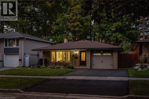 Street view of a single-story brick house with a garage and manicured lawn. - 150 Coach Hill Drive, Kitchener