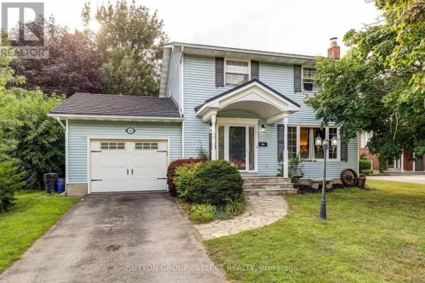 Light blue siding exterior of a house with a single car garage and stone walkway. - 150 Dufferin Street, Aylmer