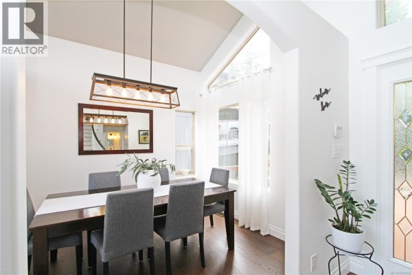 View from entrance through living room to large windows and French doors. - 150 Rainbow Cres, Nanaimo