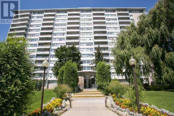 Exterior view of a multi-story apartment building with balconies and landscaping. - 1501 - 120 Shelborne Avenue, Toronto