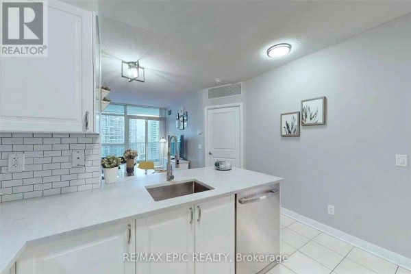 View from kitchen island showing living area with balcony and city view. - 1501 - 4978 Yonge Street, Toronto