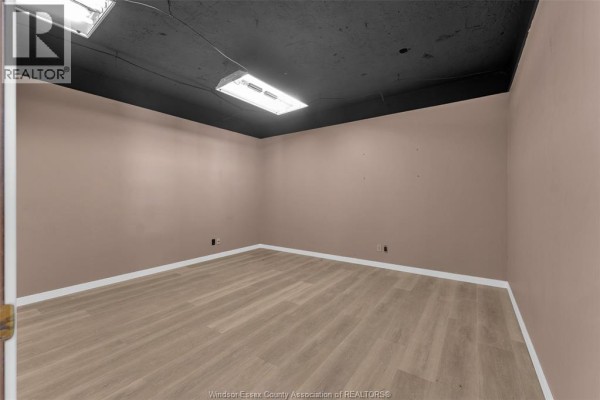 Small interior room with light walls, wooden flooring, and overhead lighting. - 1501 Howard Avenue Unit# 201c, Windsor