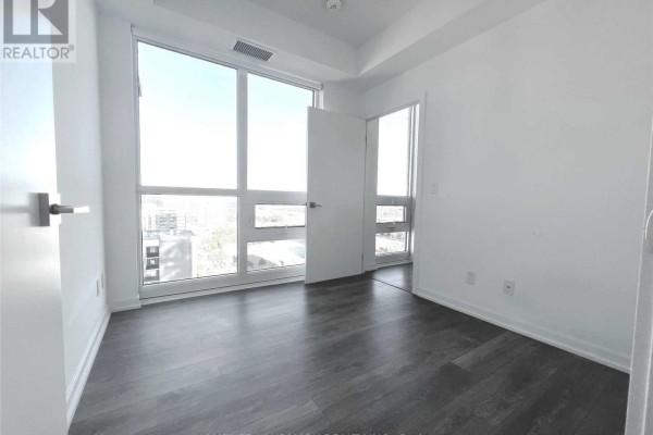 Bedroom with floor-to-ceiling windows and a balcony door. - 1502 - 56 Forest Manor Road, Toronto