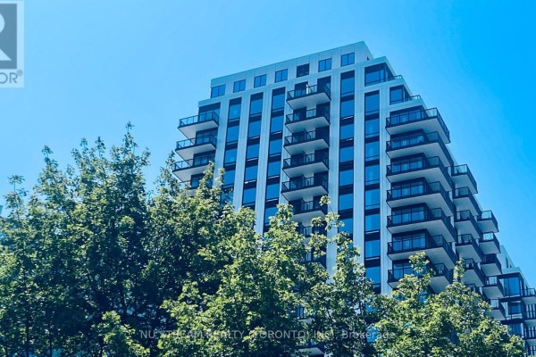 A tall condo building with many balconies is partially obscured by green trees. - 1502 - 91 Montclair Avenue, Toronto
