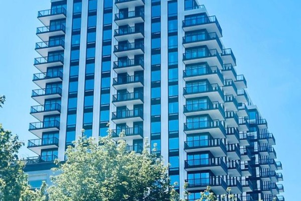 Close-up view of a condo building's facade, showing numerous glass-enclosed balconies. - 1502 - 91 Montclair Avenue, Toronto